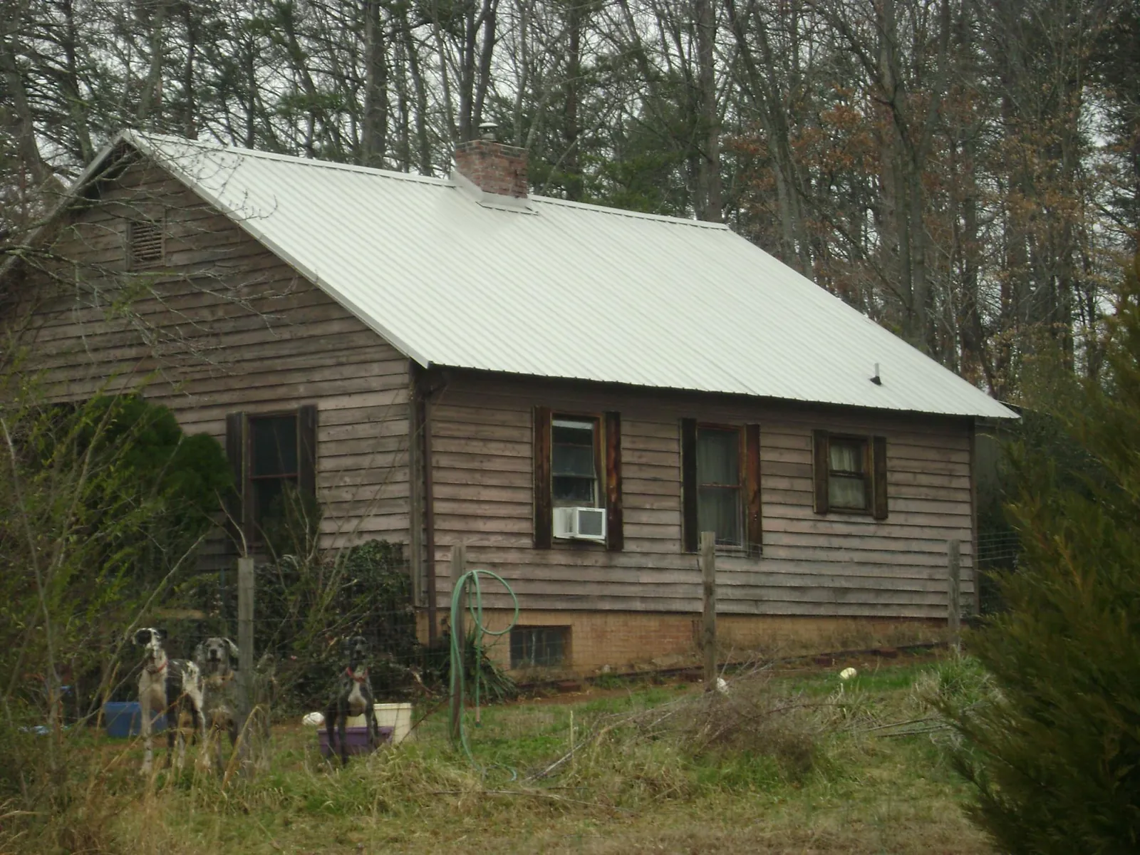 White metal roof on an old wood sided farmhouse, from a Metal Roof Installation job in Bluffton